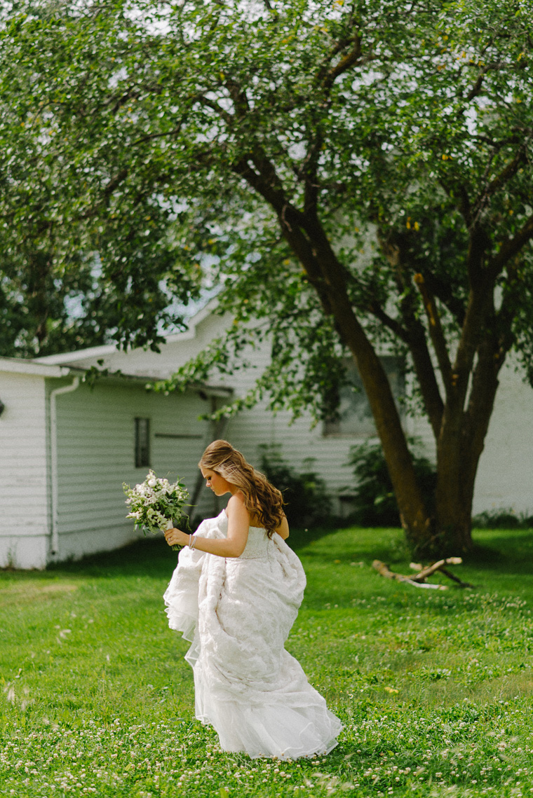 bride walking in field 