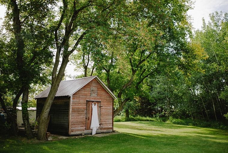 wedding dress hanging on barn