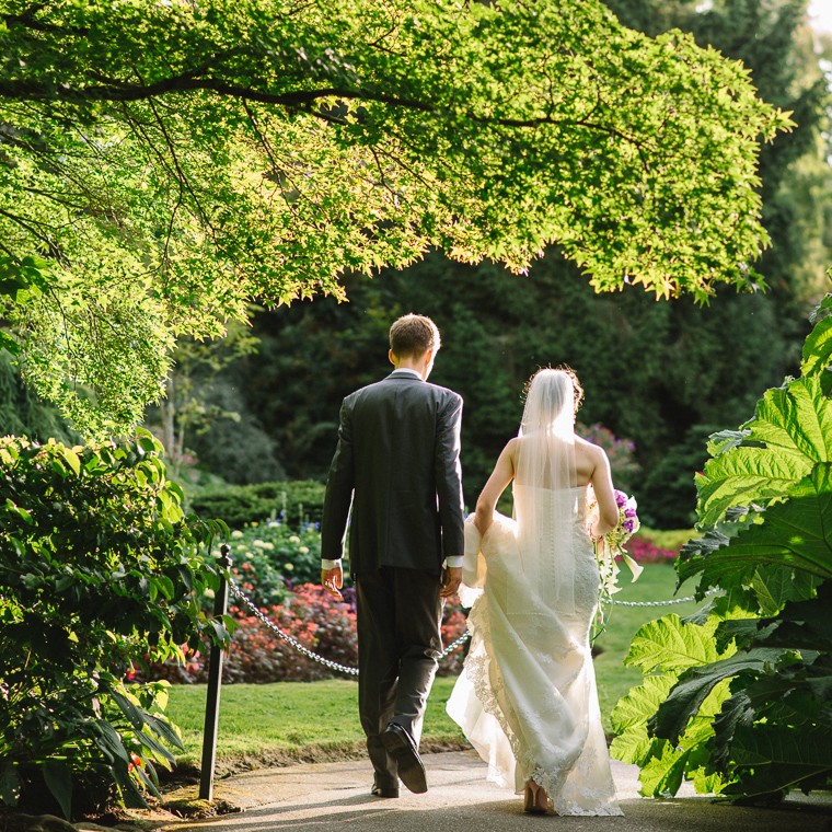 bride and groom walking in queen elizabeth park