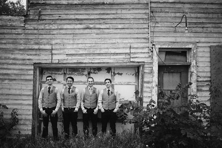 groomsmen in front of run down building