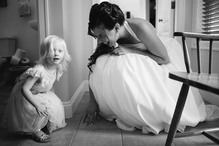 candid wedding moment with flowergirl