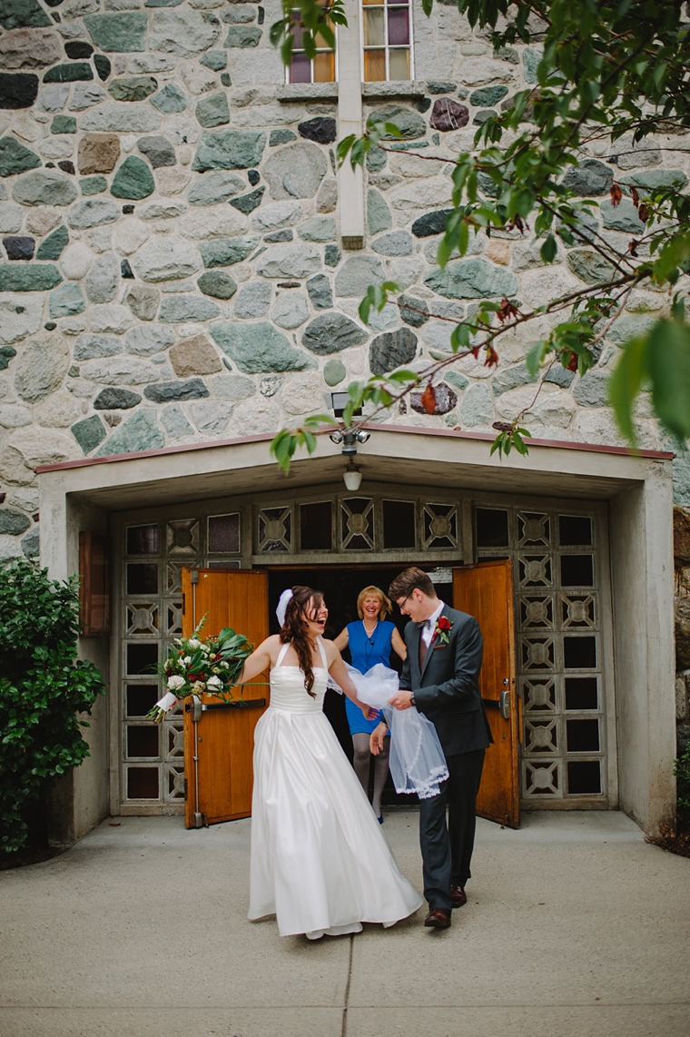 bride and groom laughing as they leave church