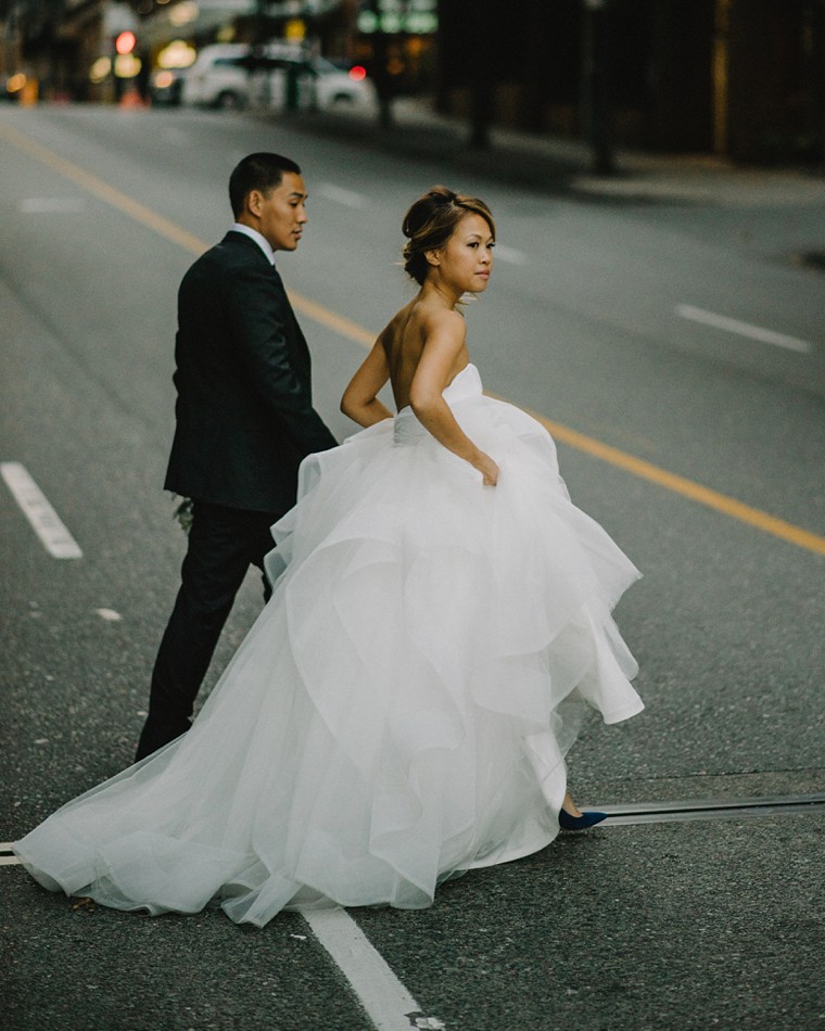 bride and groom crossing the street in vancouver