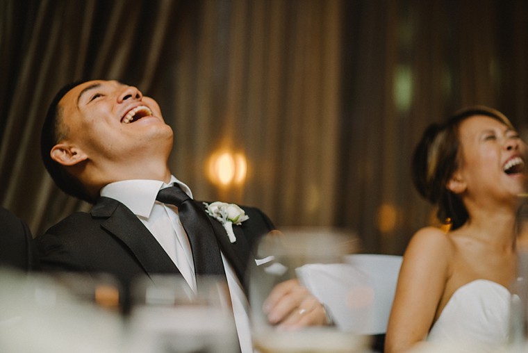 groom laughing during wedding reception