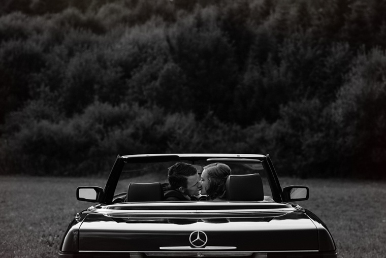 wedding portrait with a convertible in a field